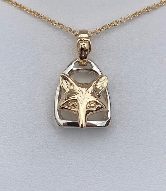 Handcrafted in sterling silver and 14k gold, the Fox & Stirrup Pendant combines two enduring equestrian symbols to honor tradition, horsemanship, and country life.
