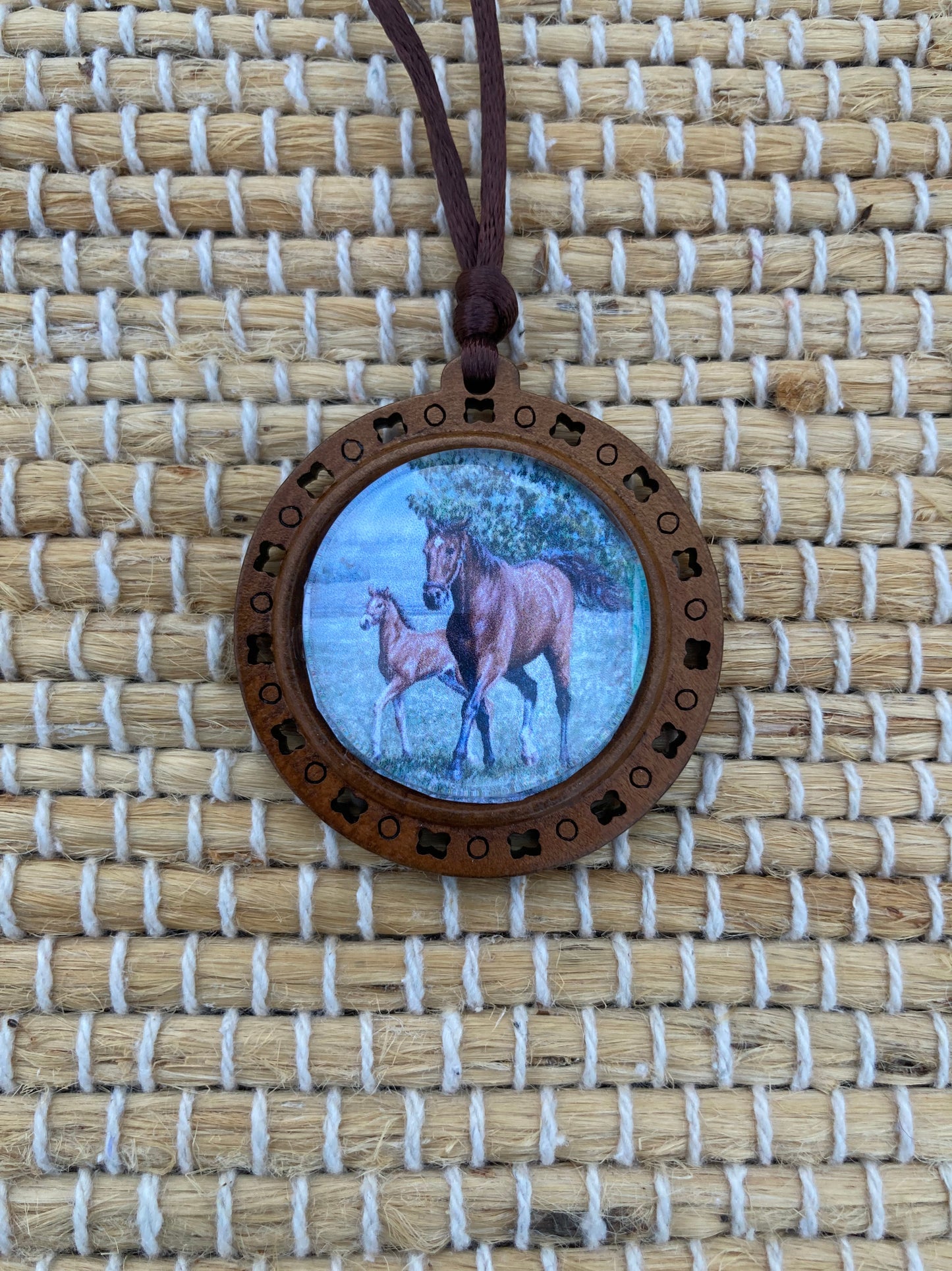 Mother's Day Equestrian Keepsake pendant featuring original artwork by Salina Ramsay of a mare and foal beneath a crystal setting, symbolizing the timeless bond between mother and child.