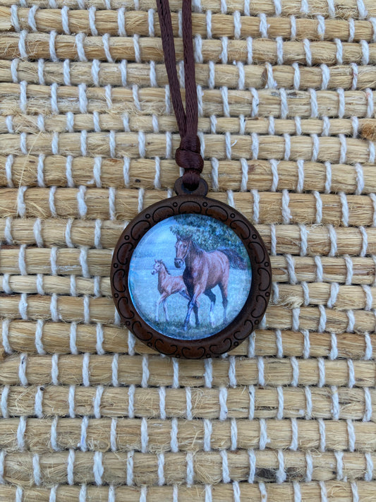 Mother's Day Equestrian Keepsake pendant featuring original artwork by Salina Ramsay of a mare and foal beneath a crystal setting, symbolizing the timeless bond between mother and child.