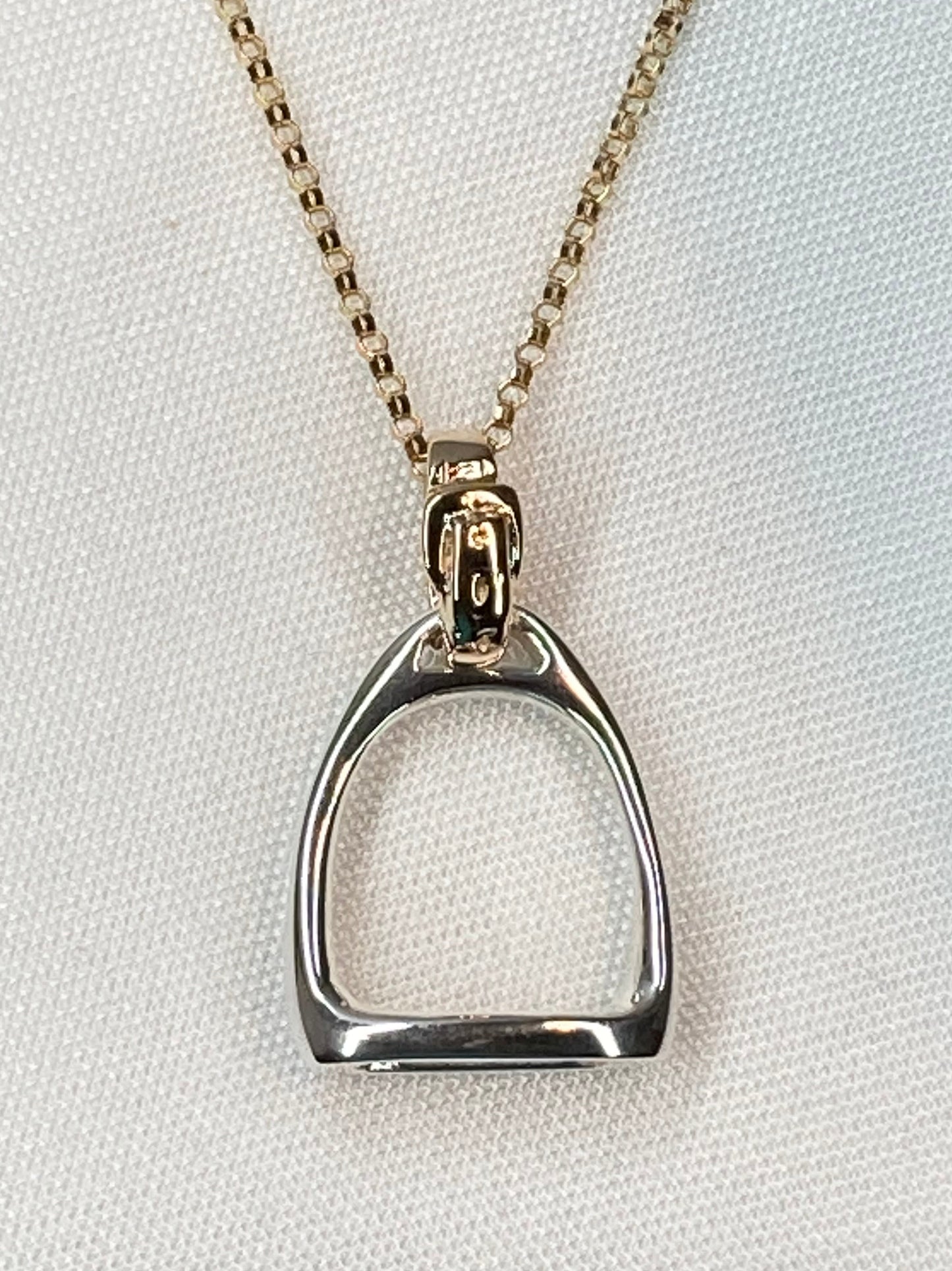 Equestrian Stirrup Pendant by Salina Ramsay, inspired by the classic English stirrup and the enduring partnership between horse and rider. This sculptural design symbolizes balance, trust, and the traditions of the sporting life.